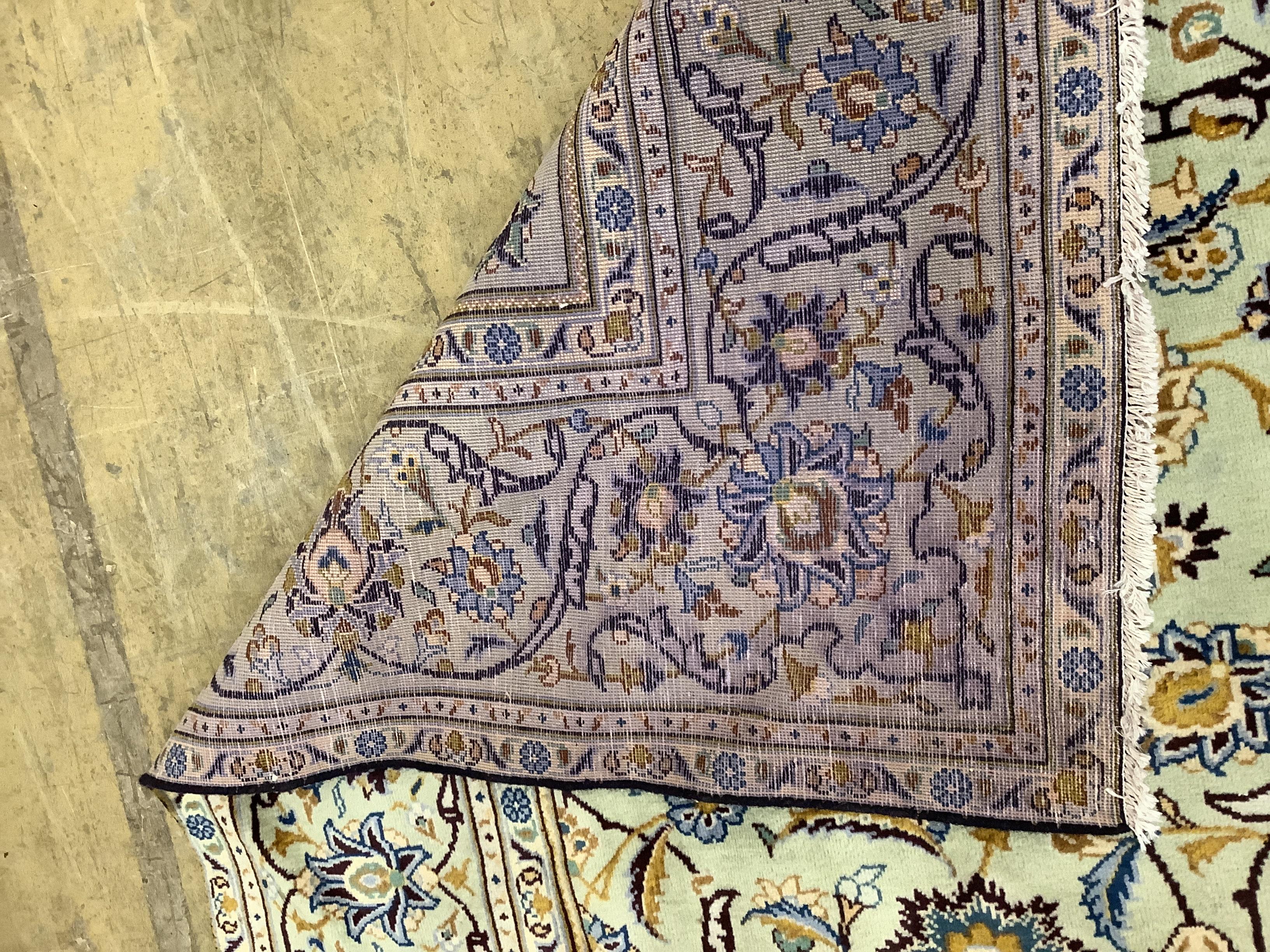 A Kashan pale green ground carpet, 310 x 207cm